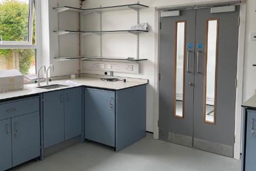 A science lab with cabinets and shelves