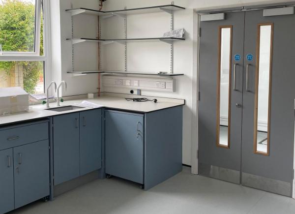 A science lab with cabinets and shelves