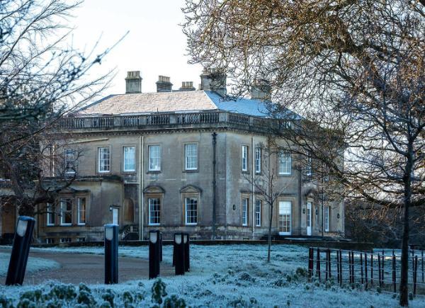 Main House building in the winter surrounded by frozen grass and trees