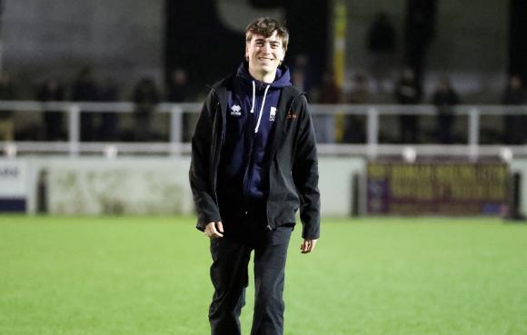 A man walking across a football field