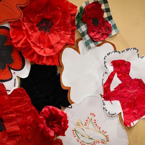 artwork inspired by the remembrance poppy displayed on a wooden wall