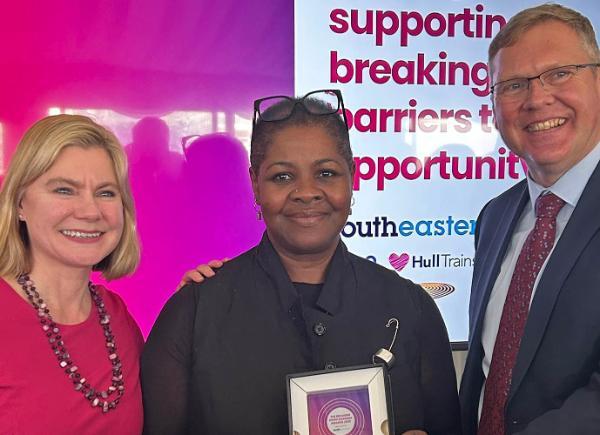 Dr Sharon Colilles poses with her award next to Justine Greening MP