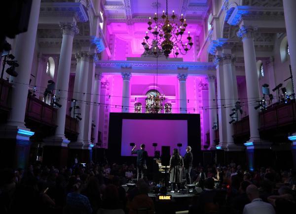 A performance hall with a purple hue