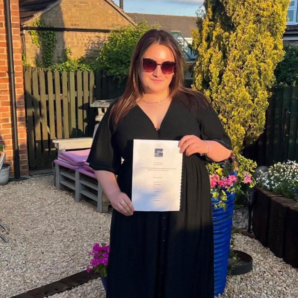 A student holding her dissertation