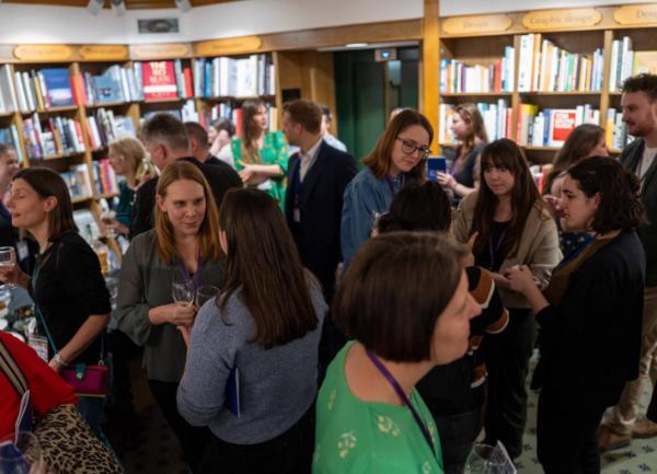 A group of people gather for an anthology launch event