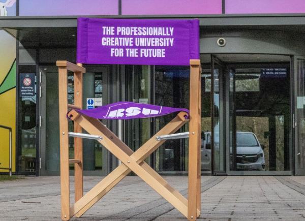 Purple chair in front of Commons building