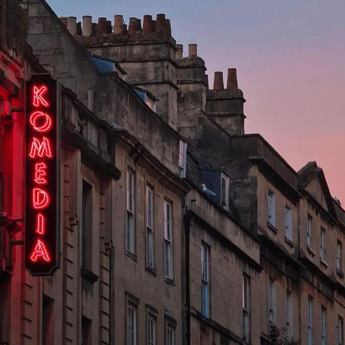 the Komedia building at sunset