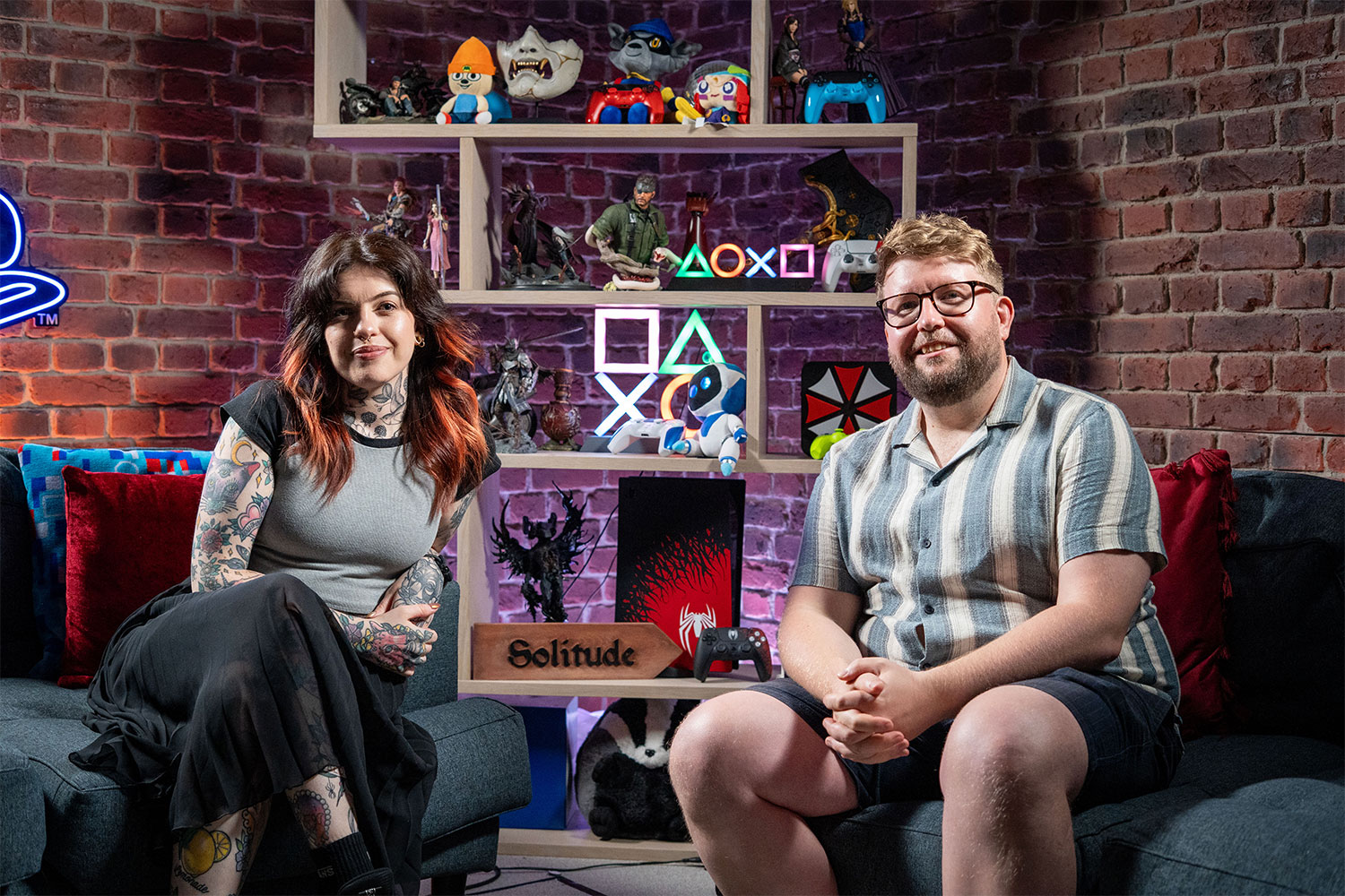 Two people sat in front of a busy filming set