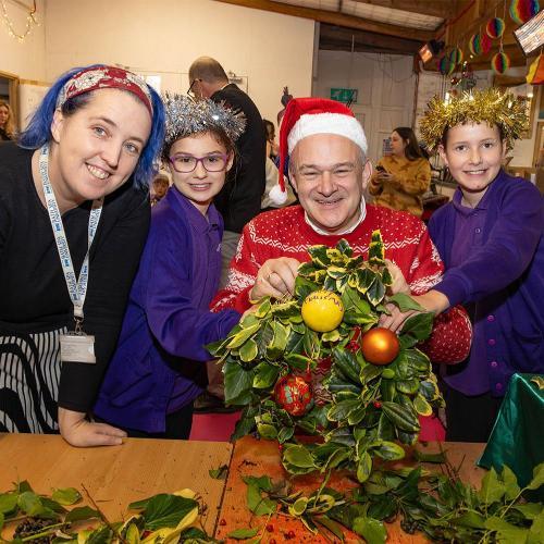 politician Ed Davey making wreaths with primary school children