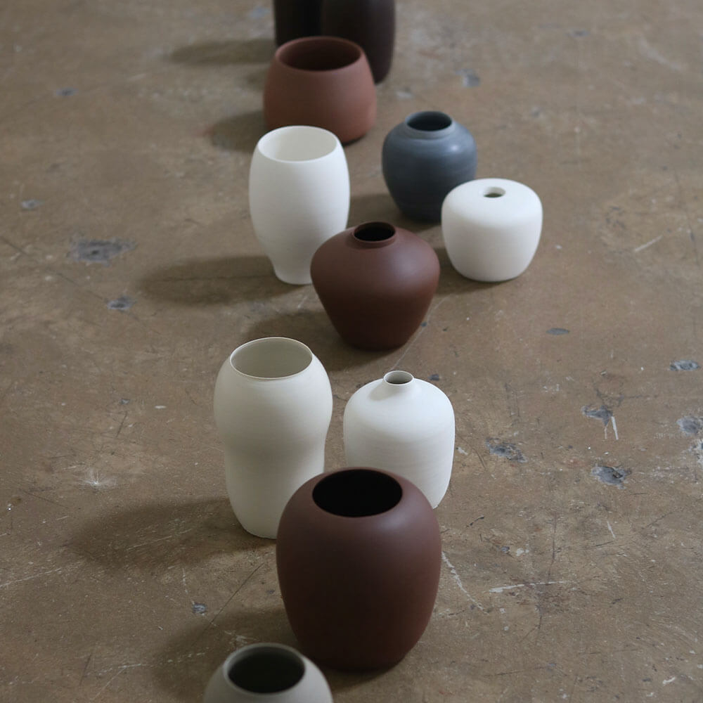 A collection of vases in white and grey pots
