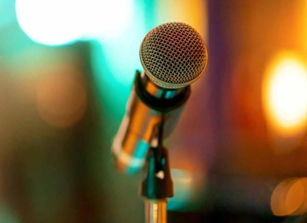 Microphone on stage abstract crowd blurred background