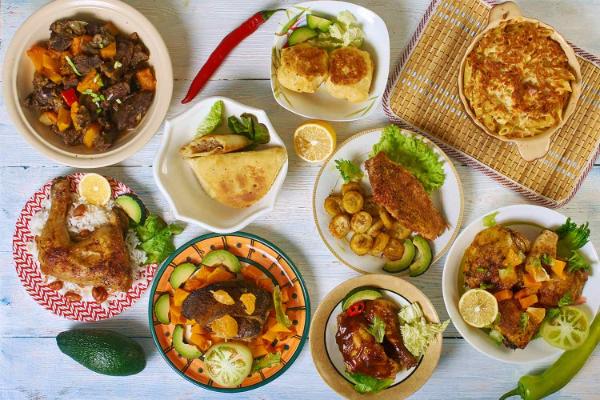 Overhead photo of plates of colourful afro-caribbean food