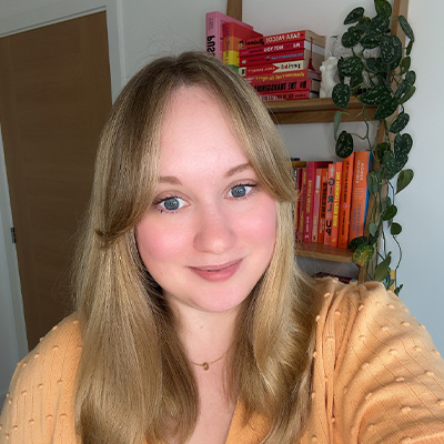 Headshot of someone with long blonde hair and yellow top
