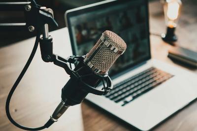 Microphone over laptop in home podcast set up