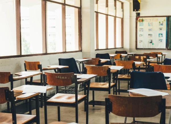image of classroom with empty desks in rows