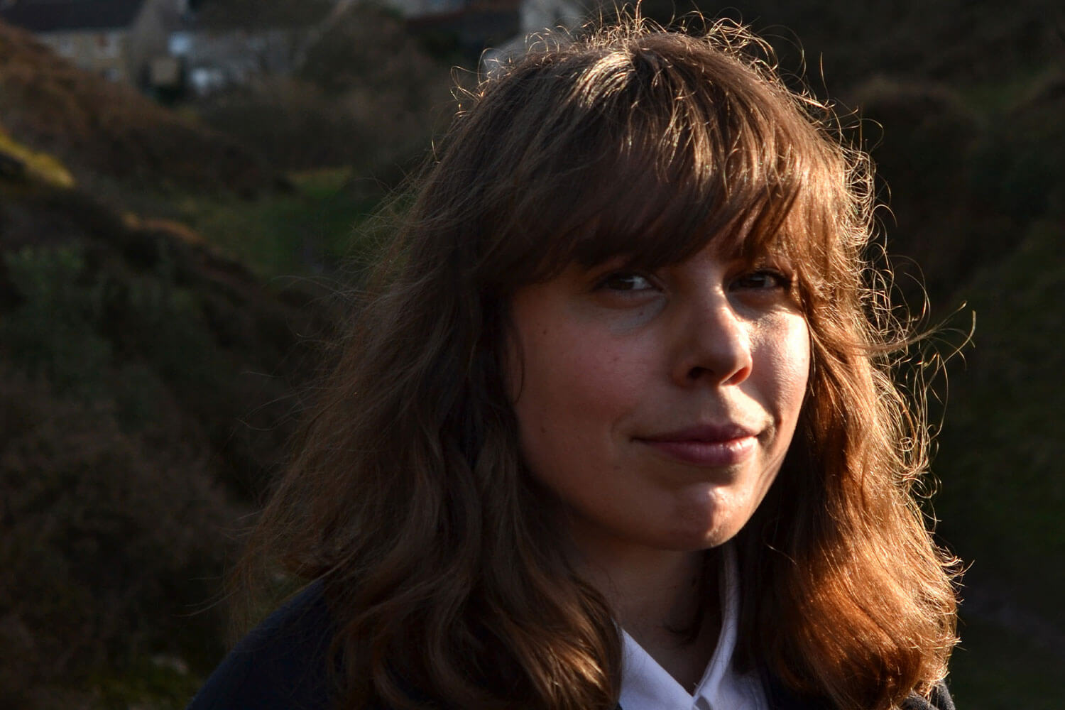 Lecturer Hannah Chapman stood in a field