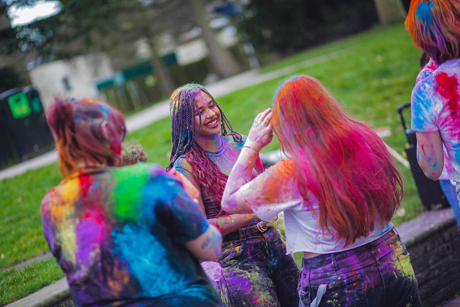 A group of girls celebrating Holi, covered in paint