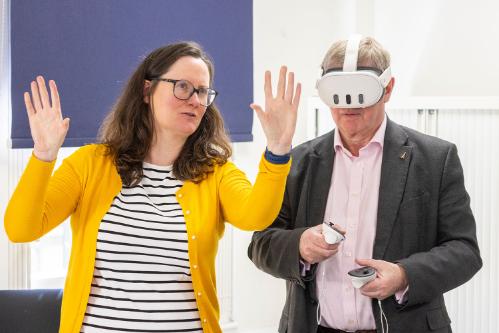 Woman explaining VR to a man in VR glasses