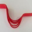 Red curved shelf on a white wall.