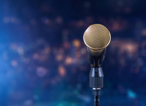a close up of a microphone in a stand set up on a stage