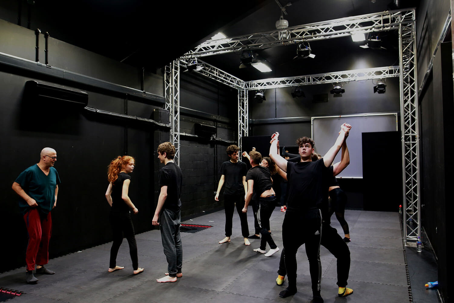 Students working in a black box space