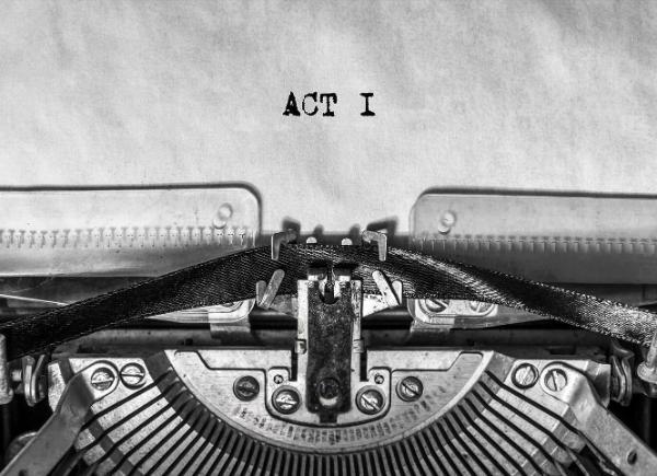 A page on a typewriter with the words 'Act 1' on it
