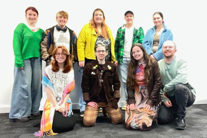 A group of people stand together for a posed photo