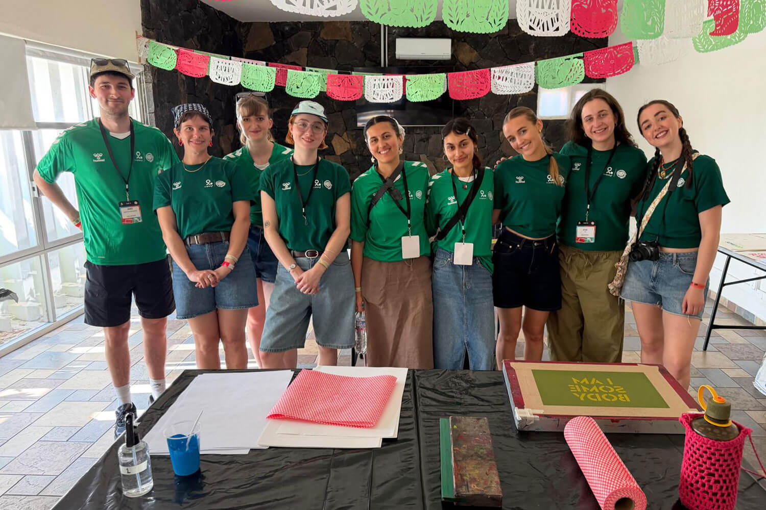 a group of students stood in a group in front of art supplies