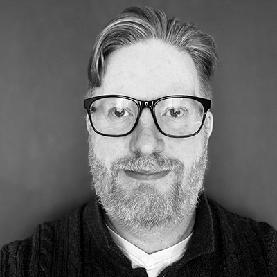 A black and white head shot of a Bath Spa University staff member.