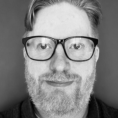A black and white head shot of a Bath Spa University staff member.