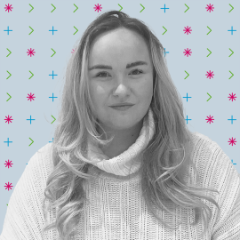 A person wearing a cream knitted sweater with long blonde hair