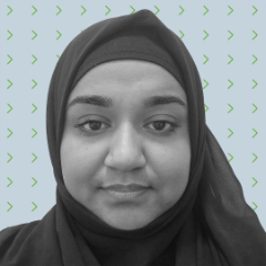 A person wearing a dark hijab looks at the camera