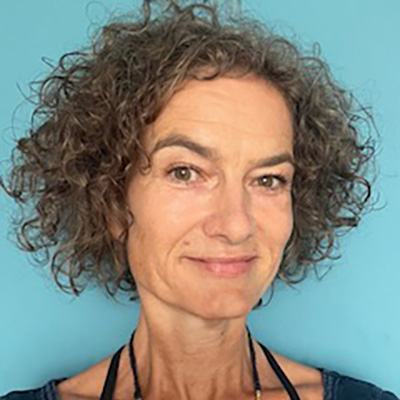 Profile headshot of a woman against a blue background.