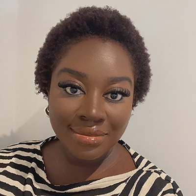 A Bath Spa staff member in a black and white striped top