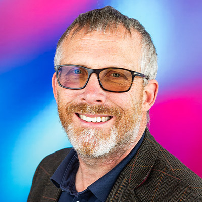 Headshot of someone with glasses and short hair