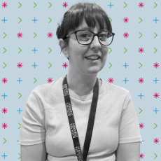 A person wearing dark-framed glasses and a BSU lanyard