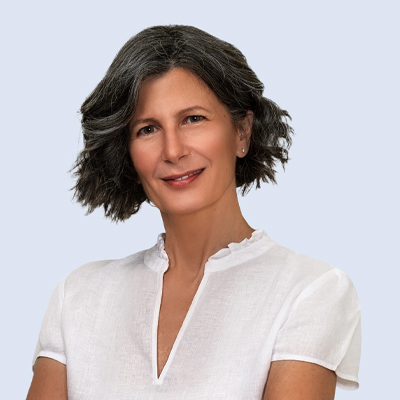 Headshot of someone with shoulder-length dark hair in white t-shirt