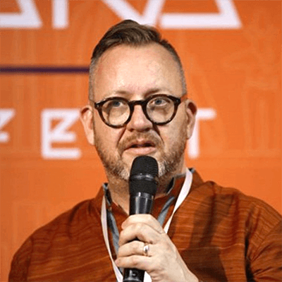 Professor Philip Hensher speaking at an event holding a microphone