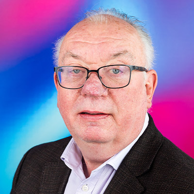 Headshot of person with glasses in shirt and blazer