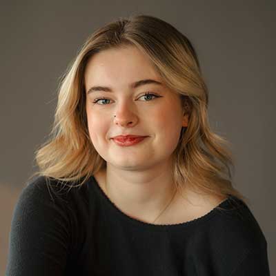 A headshot for a person with long blonde hair