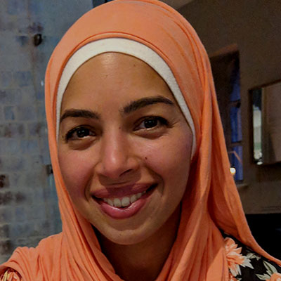Smiling woman wearing an orange hijab
