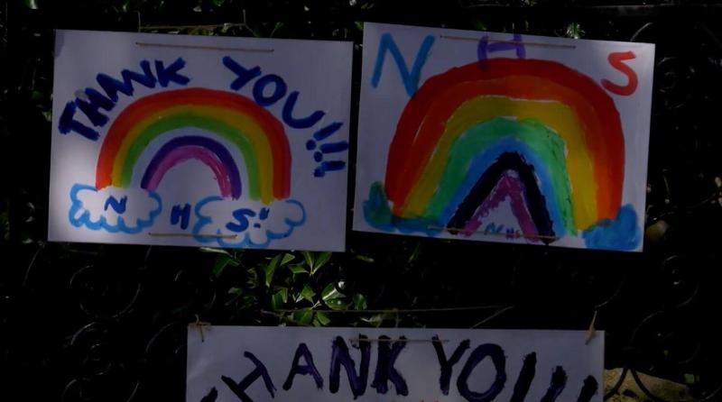 Rainbow drawings by children on paper thanking the NHS