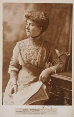 Old photograph of person with hair piled high in traditional dress. Mrs Mansel