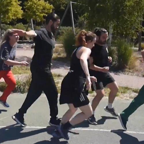 Performers running through a playground.