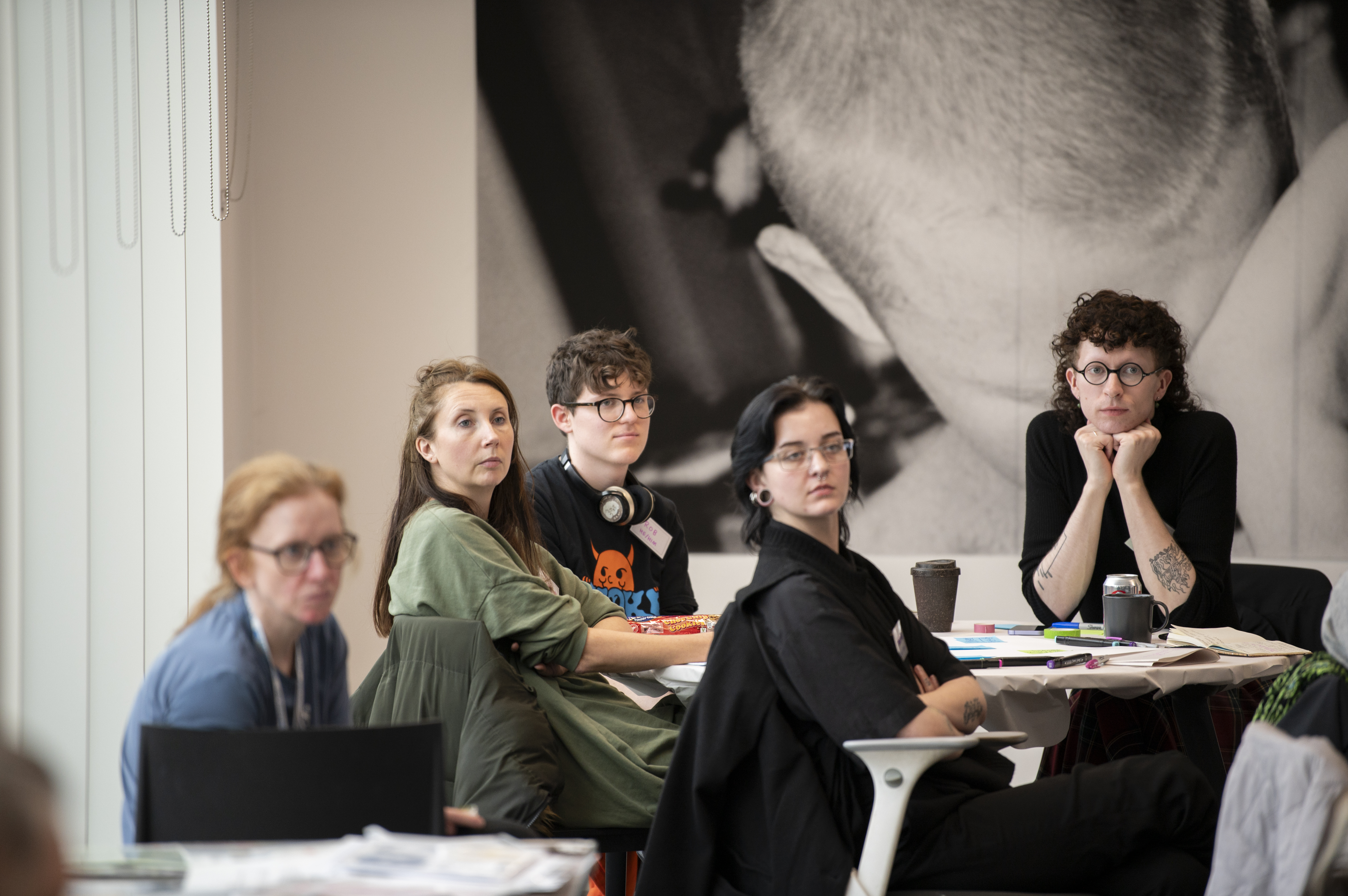 A group of people listening to a speaker