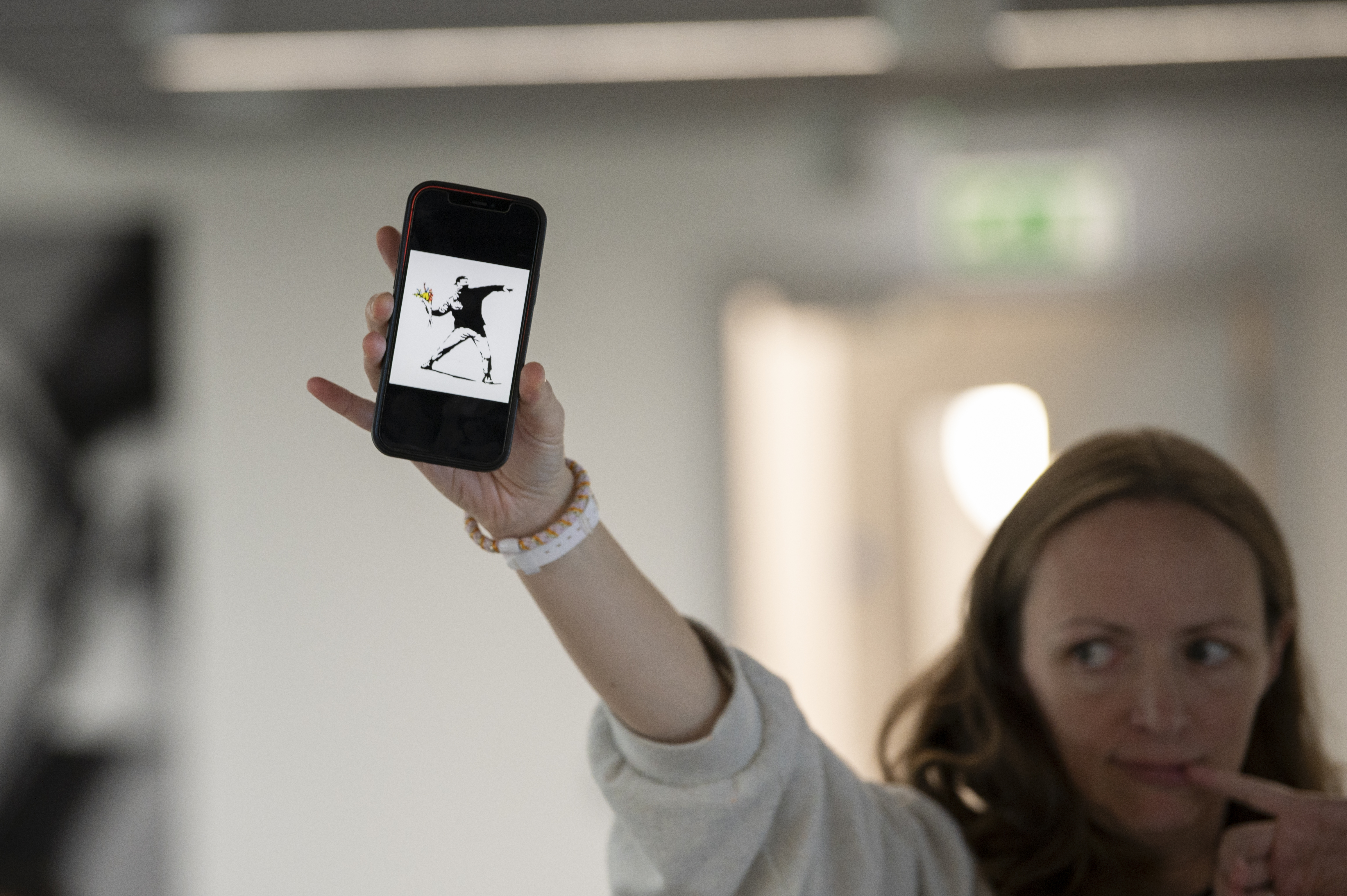 A person holding a phone in the air