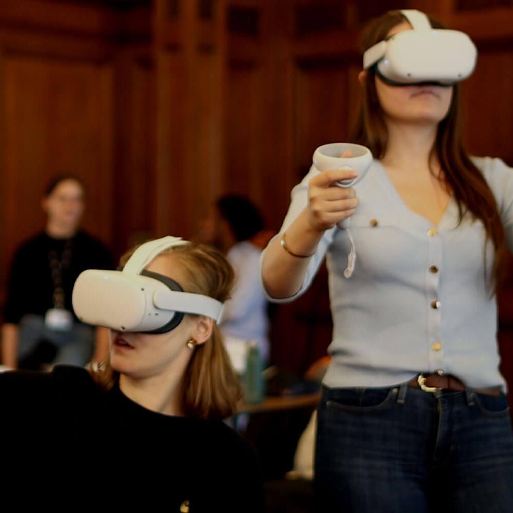 Teens using VR headsets in a wood-panelled room