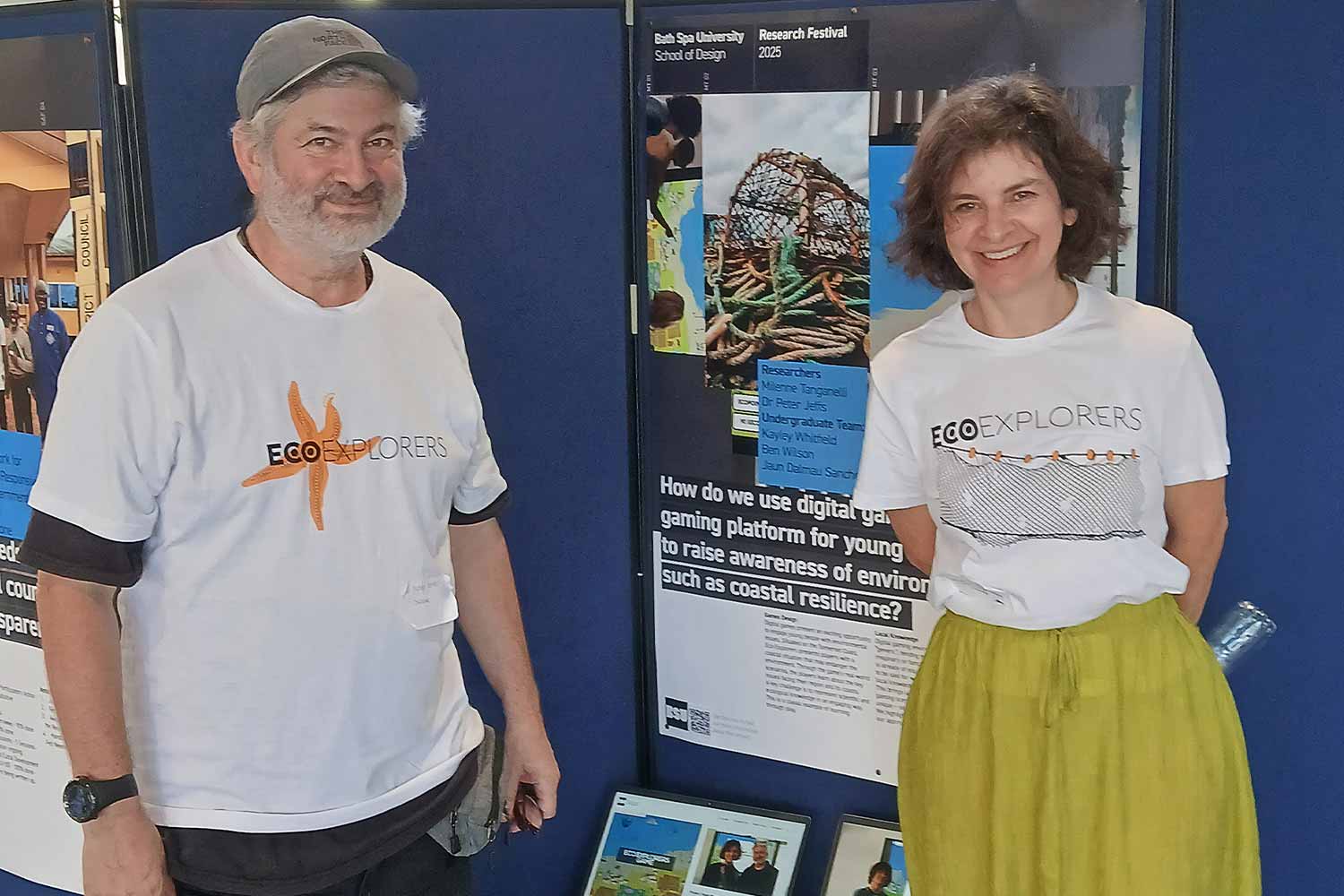 Photograph-of-two-people-in-front-of-a-computer-screen-showing-Eco-Explorers-game