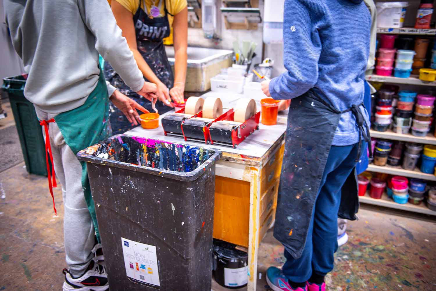 Photo of young people in a workshop mixing paint