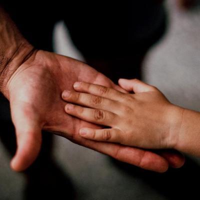 Adult and child holding hands